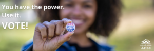 A Black woman holds a voting button. Text: "You have the power. Use it. Vote!"